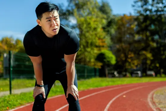 photo of Asian man tired after running.